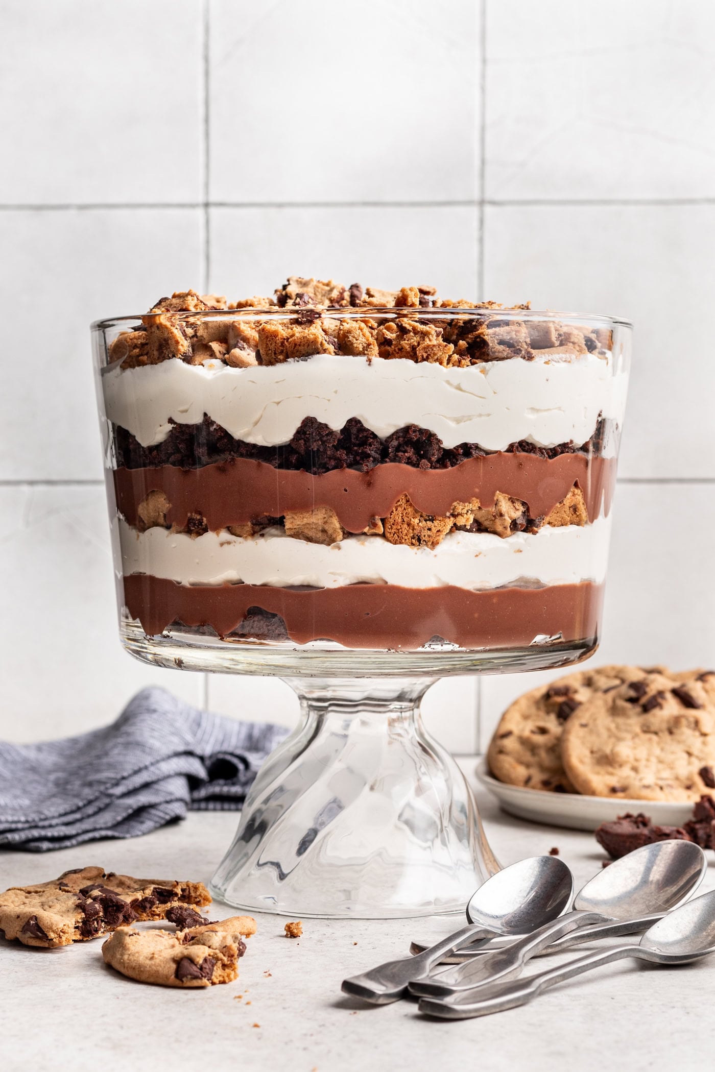 cookie brownie trifle in a glass dish with layers of chocolate pudding, whipped cream, cookies and brownies