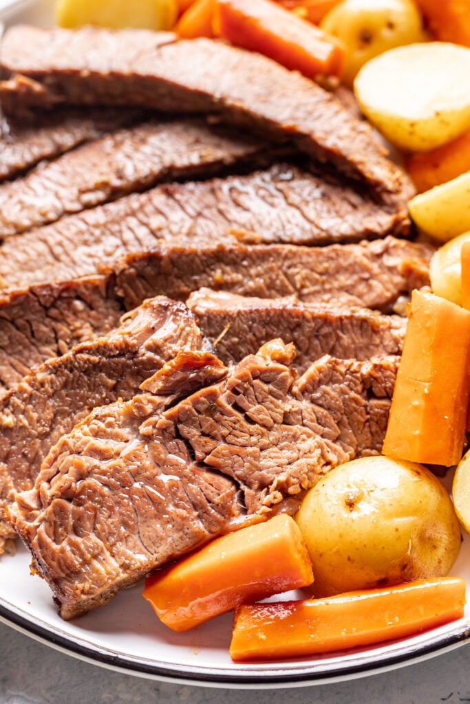 sliced brisket with carrots and potatoes