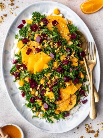 kale salad with oranges and beets on a platter