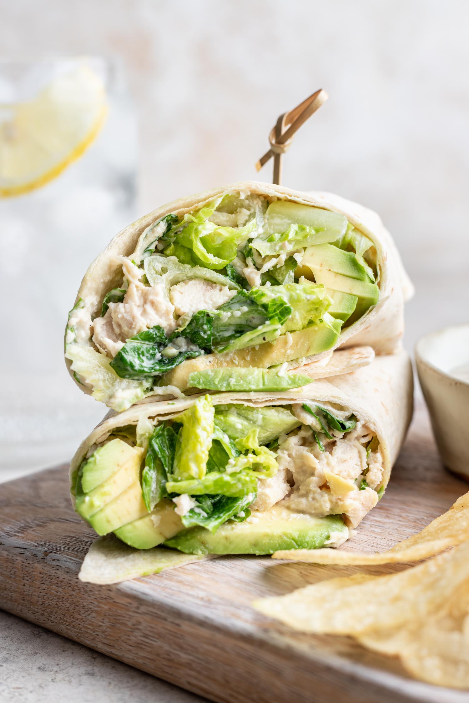 shredded chicken caesar salad wrap cut in half and stacked with a toothpick