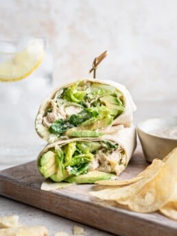 shredded chicken caesar salad wrap cut in half and stacked with a toothpick