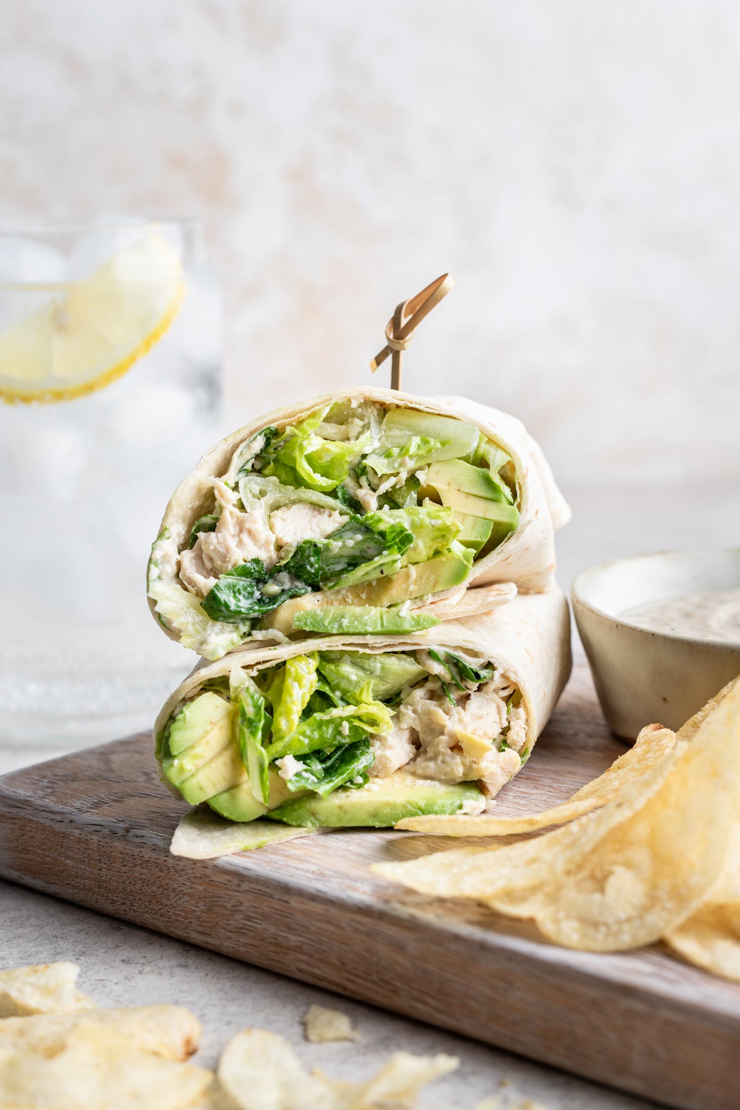 shredded chicken caesar salad wrap cut in half and stacked with a toothpick