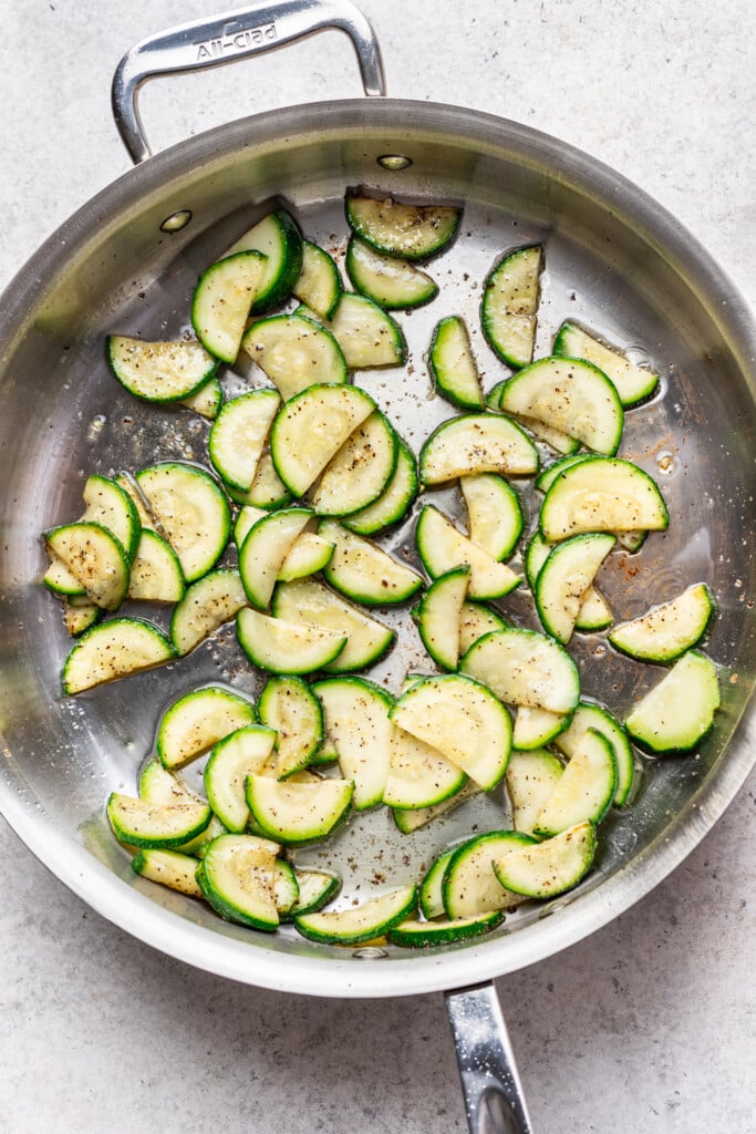 large skillet with sliced zucchini