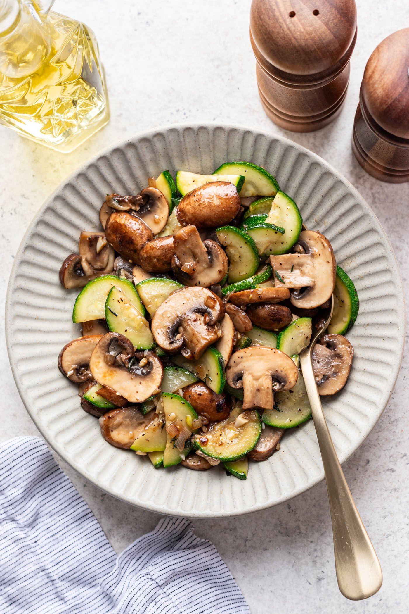 a bowl with cooked zucchini and mushrooms