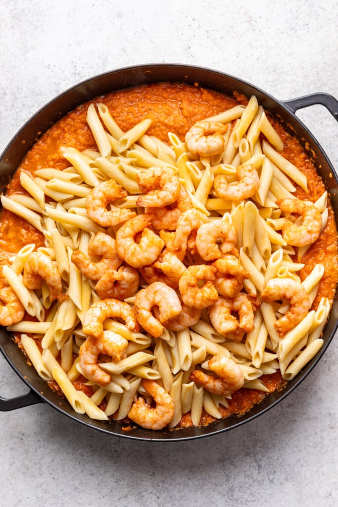 A pan filled with pasta and shrimp.