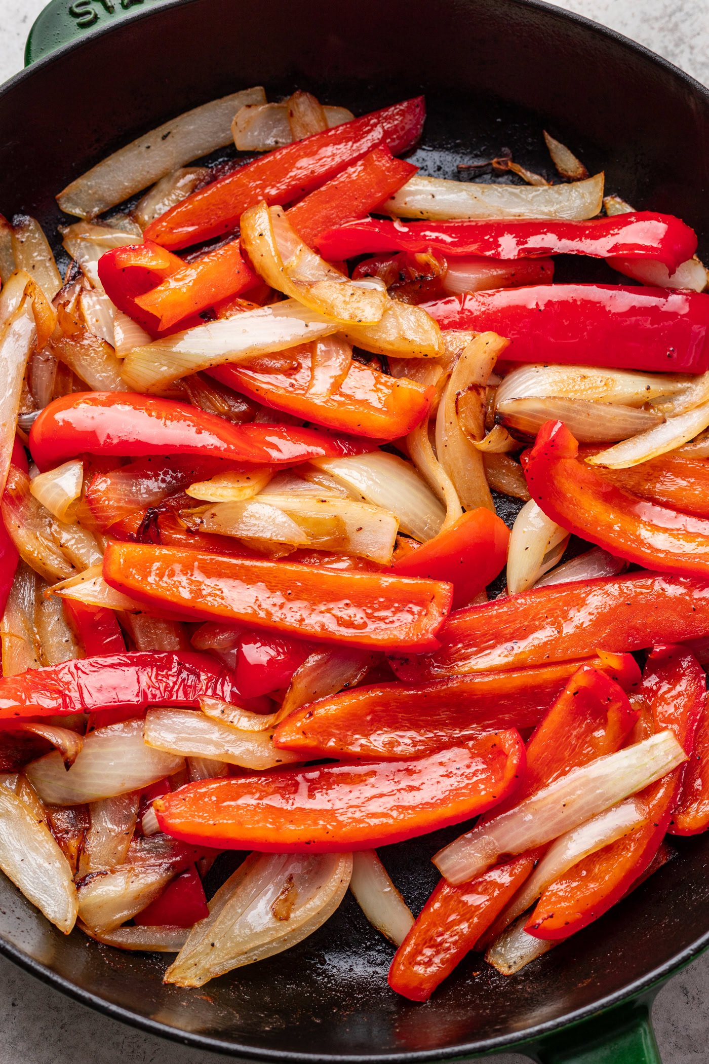 A pan with red peppers and onions