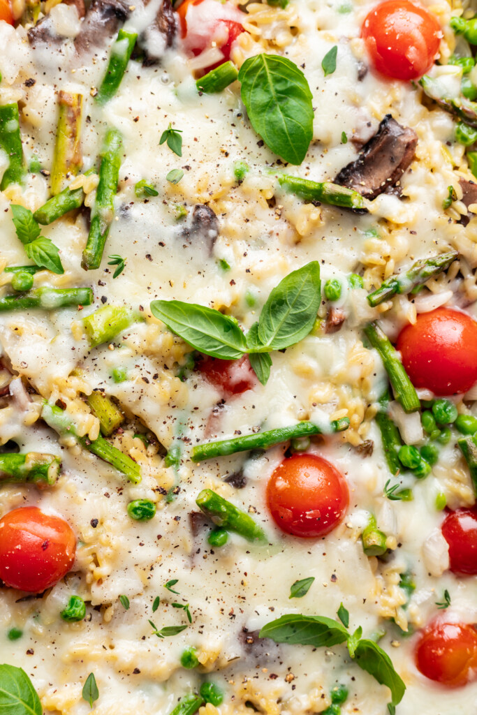 close up of baked orzo with cheesy top