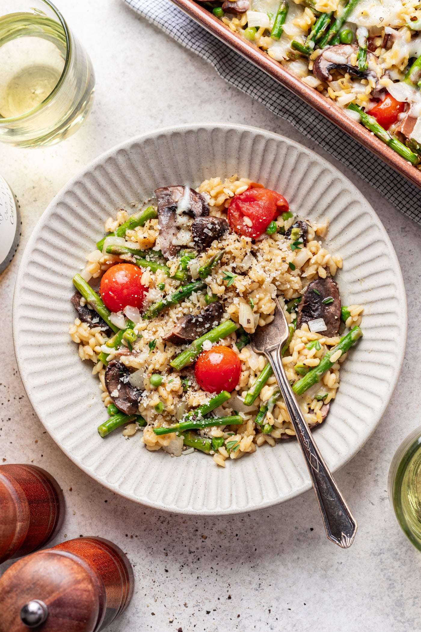 baked orzo in a bowl with a fork