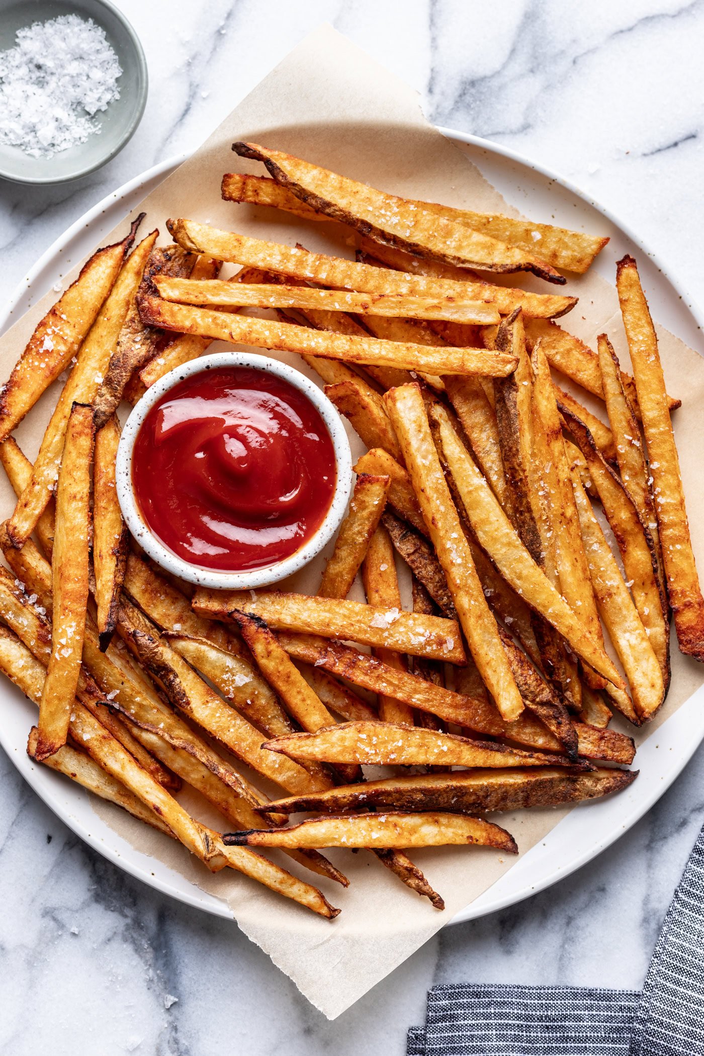 plate of oven baked fries with a small bowl of ketchup