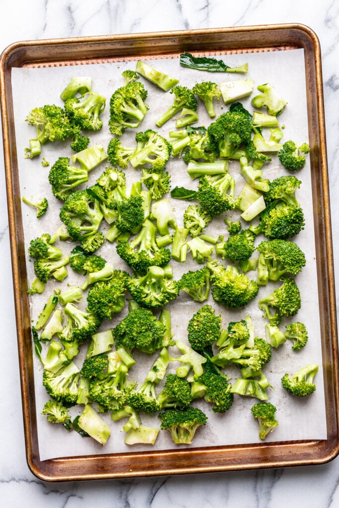 broccoli florets on a parchment lined sheet pan