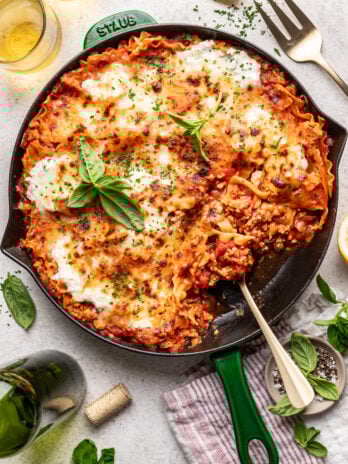 skillet lasagna with a serving spoon