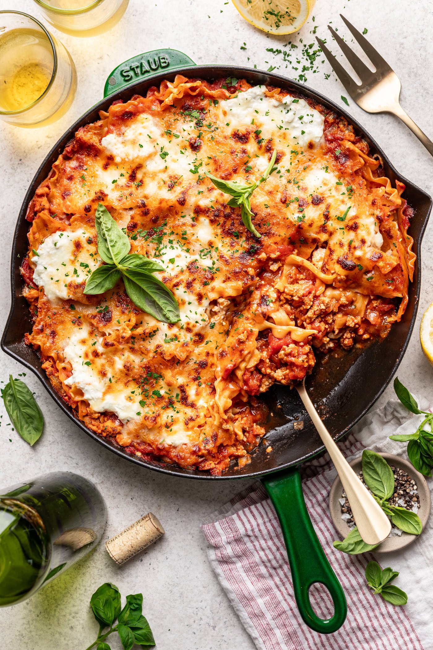 lasagna in a skillet with a serving spoon