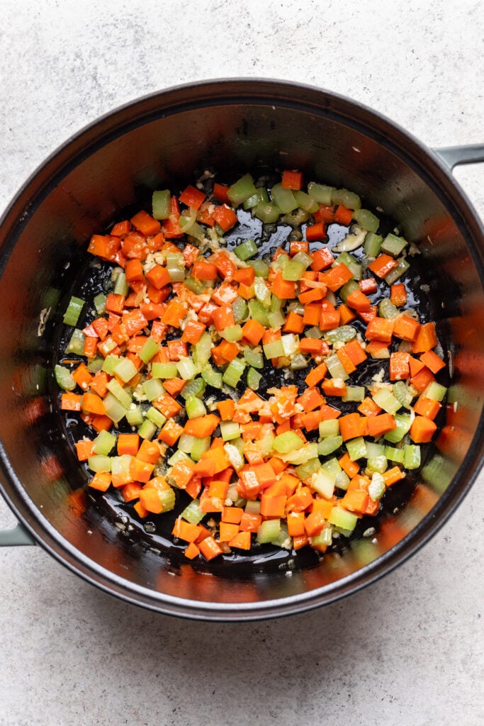 soup pot with chopped veggies being cooked