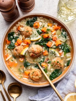 lemony chicken meatball soup in a bowl with a spoon