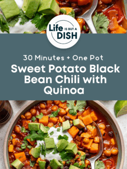 A bowl of hearty sweet potato black bean chili with quinoa, topped with avocado, sour cream, and cilantro, sits next to a spoon on a rustic table. Text reads: “Sweet Potato Black Bean Chili with Quinoa – 30 Minutes + One Pot.”.